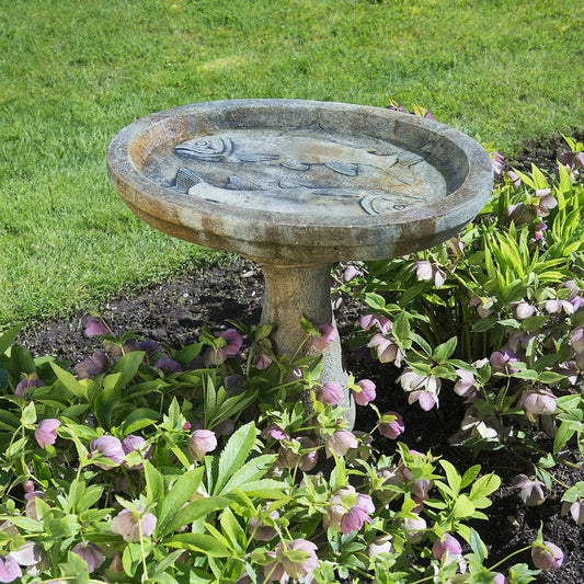 Fisherman's Birdbath. A bird bath with two trophy fish in the bowl